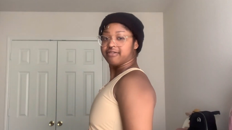A person wearing a beige chest binder, showing a safe binding fit for a larger chest